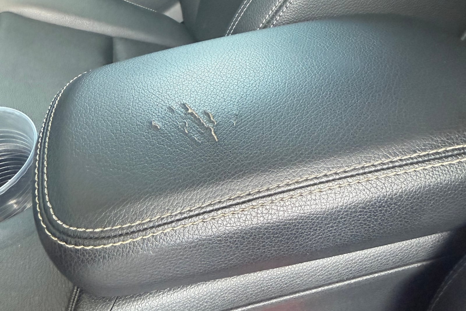Before: Gouged center console armrest — before and after repair by Dr. Vinyl DFW