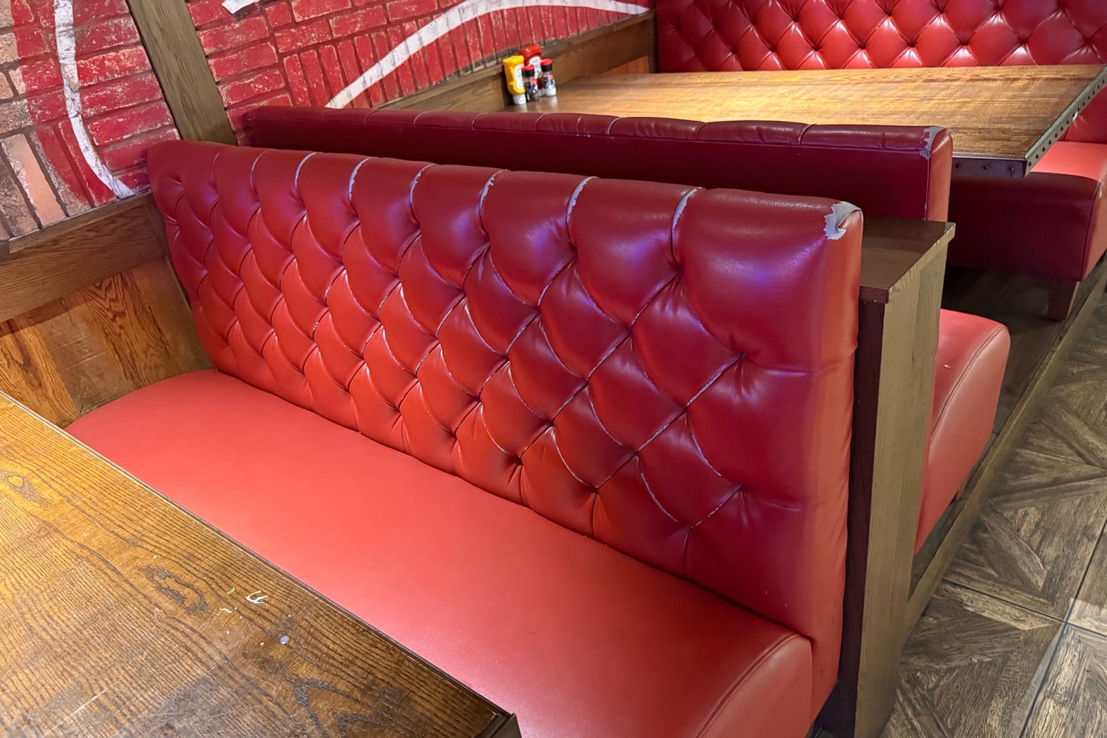 Before: Worn tufted booth backs — before and after repair by Dr. Vinyl DFW